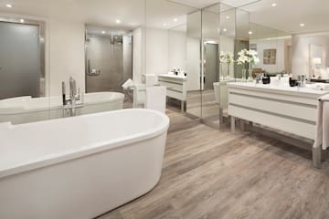 a bathroom with a large tub and a large mirror