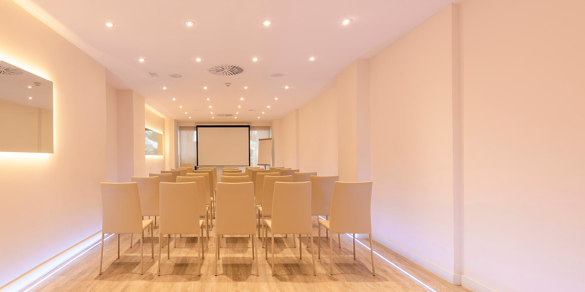 a room with chairs and a projector screen