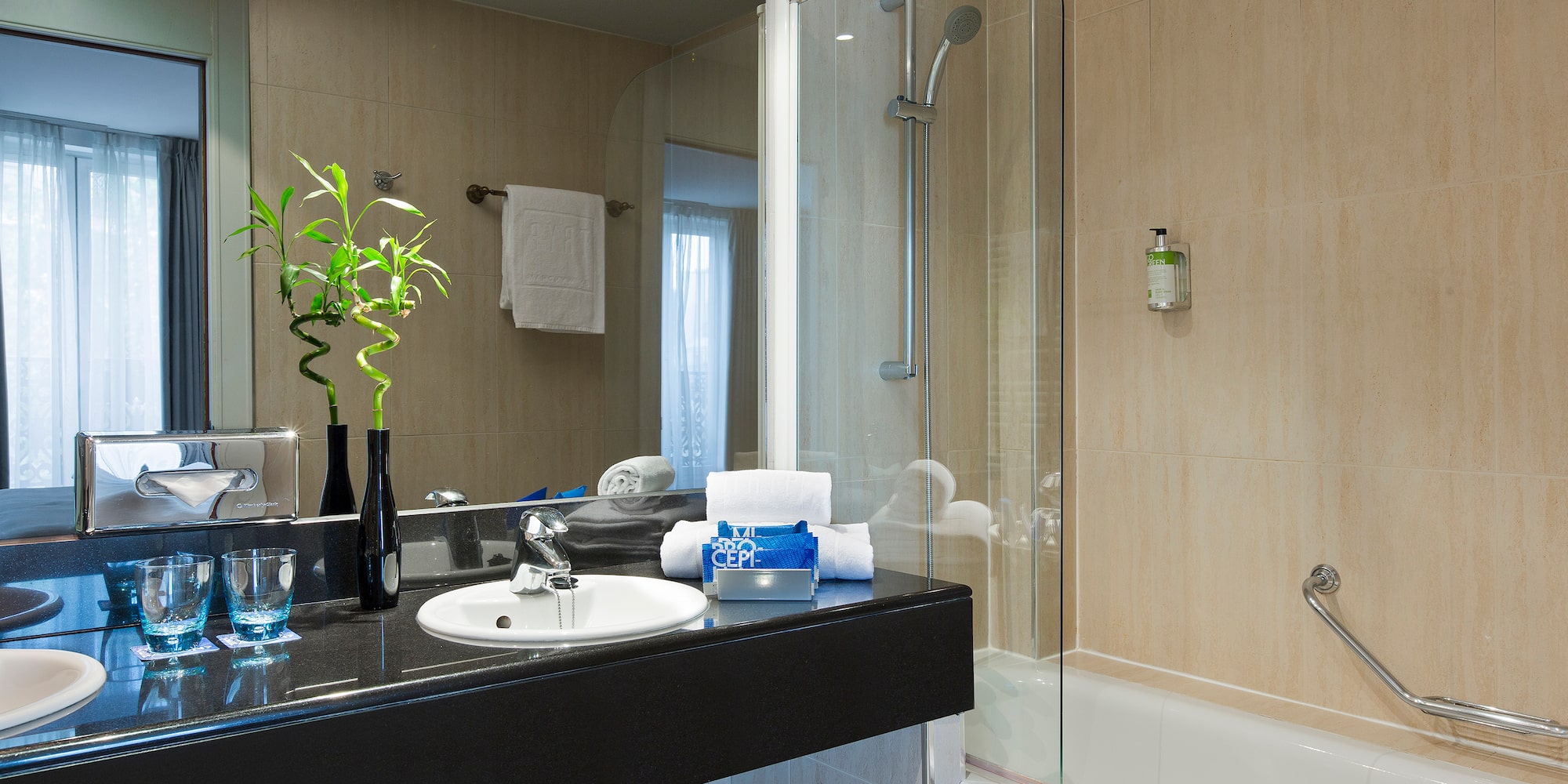 a bathroom with a glass shower and sink