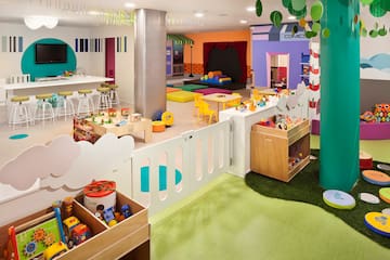 a room with a playroom and a play area