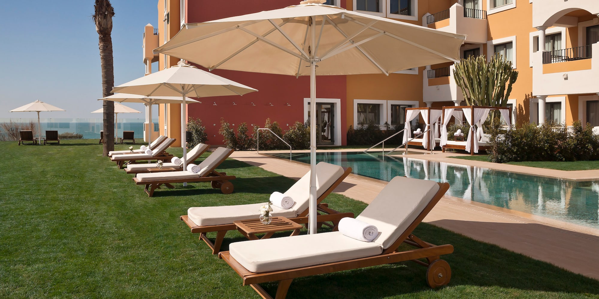 a pool with lounge chairs and umbrellas