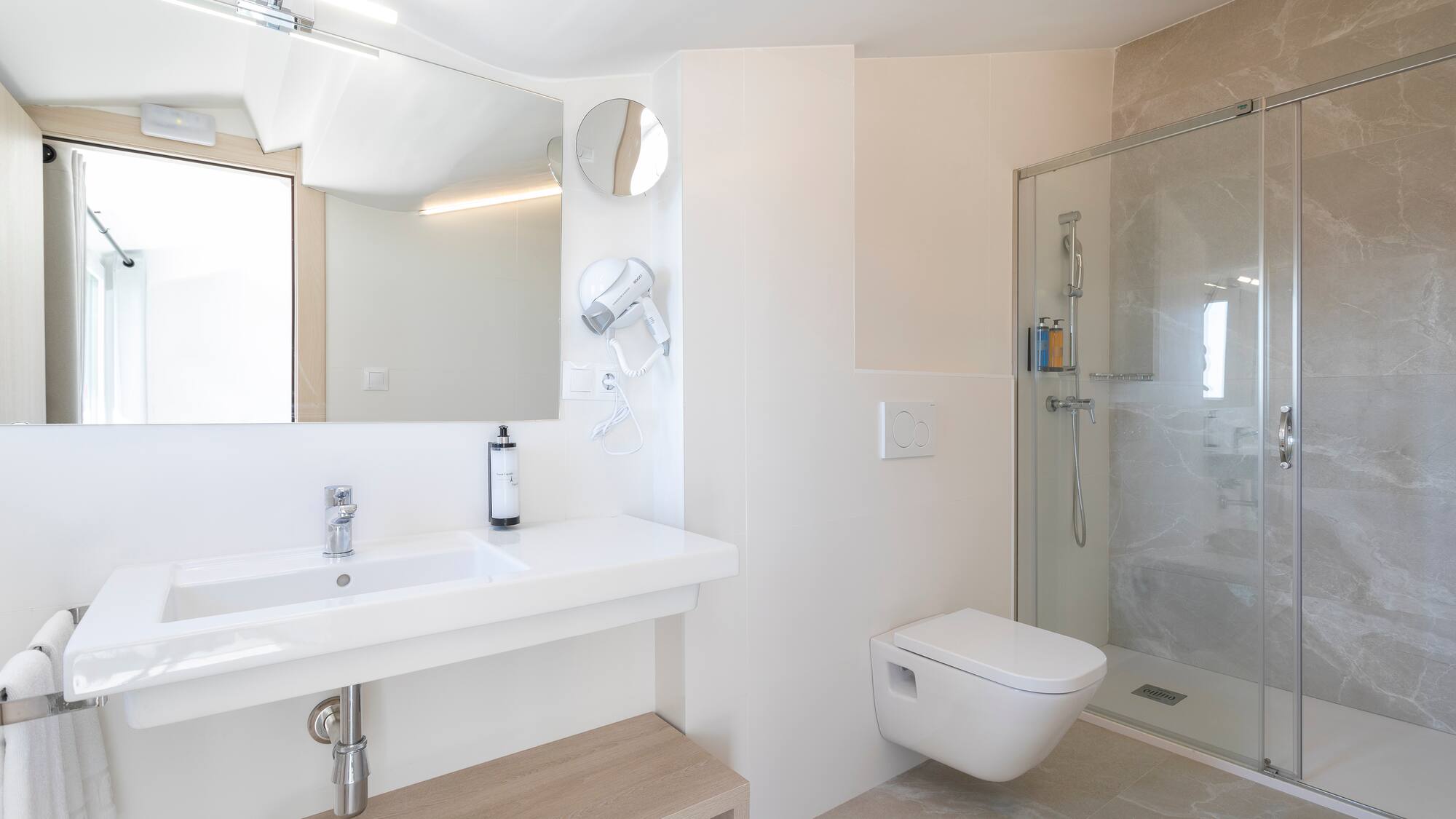 a bathroom with a shower and sink