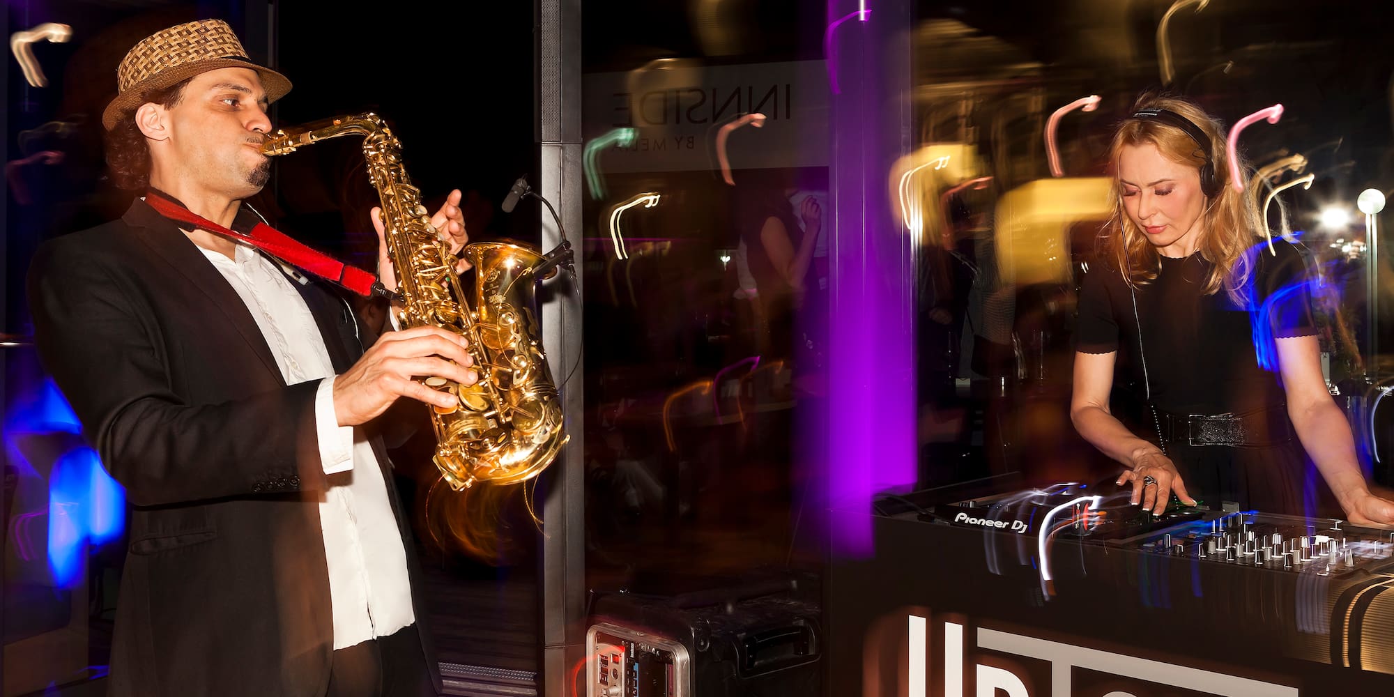 Live saxophonist and DJ set at UpTown lounge.