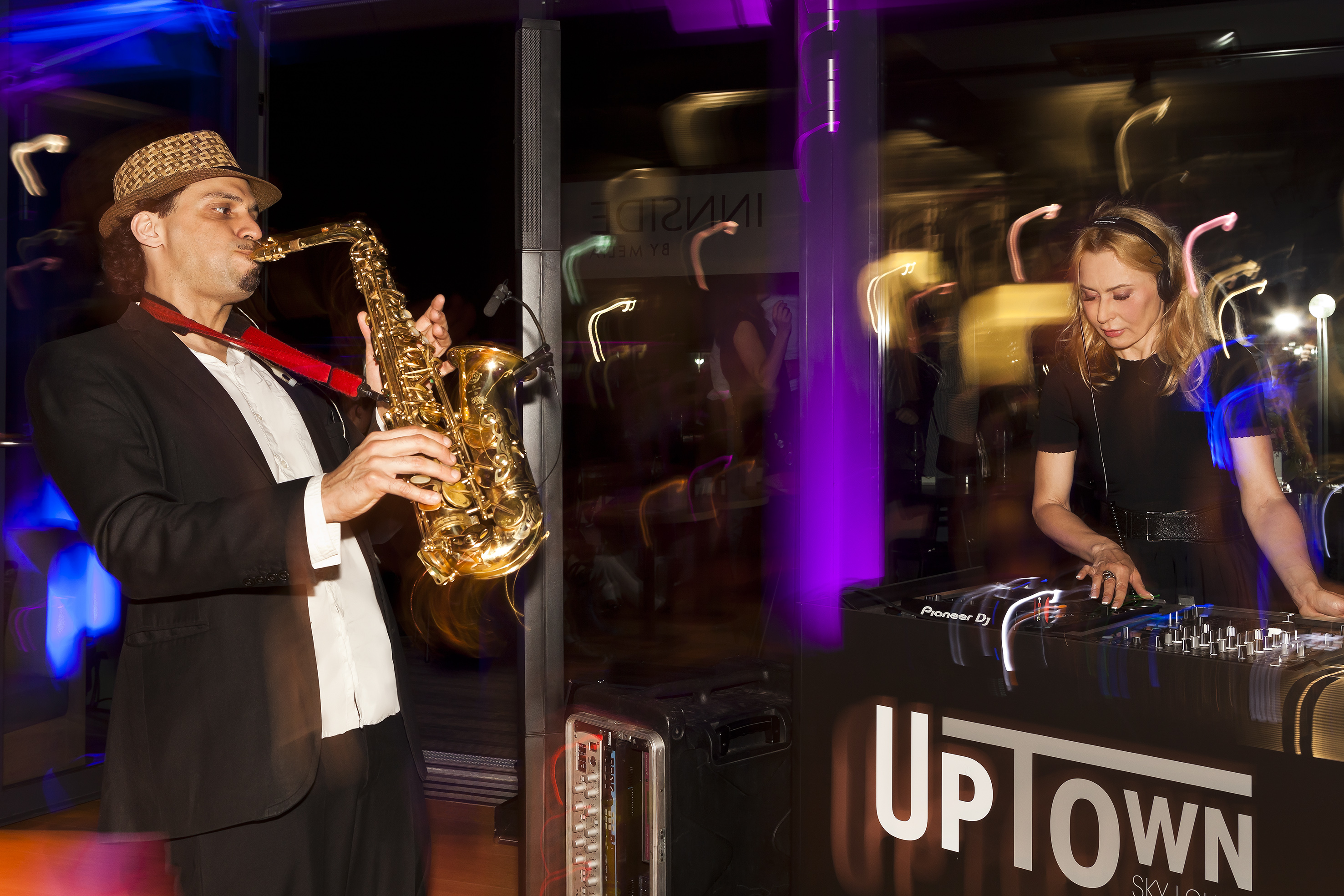 Live saxophonist and DJ set at UpTown lounge.