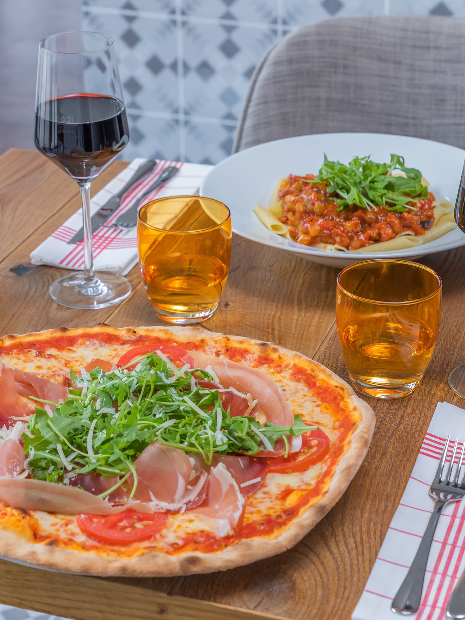 a pizza and wine glasses on a table
