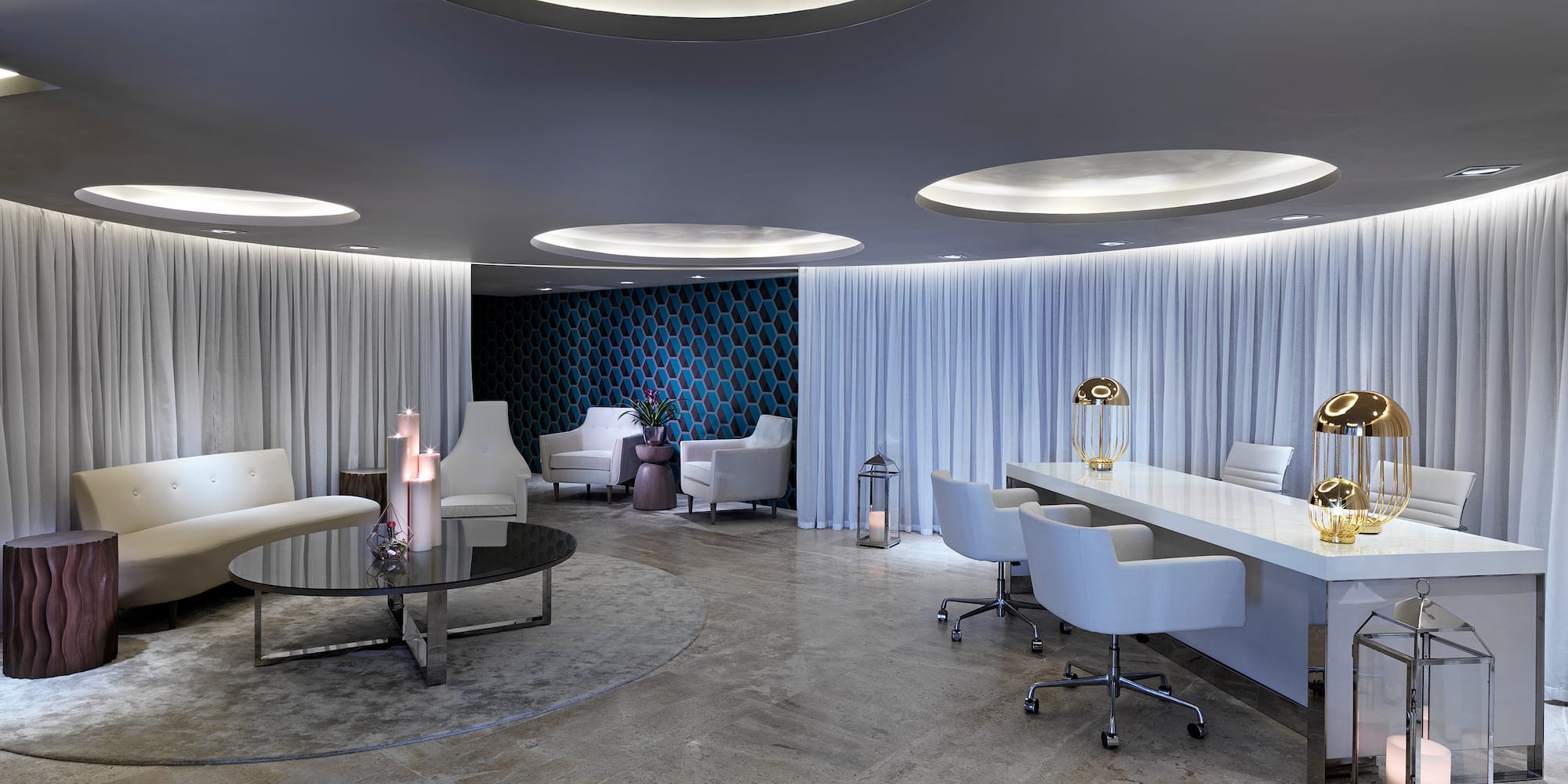 a room with white chairs and tables