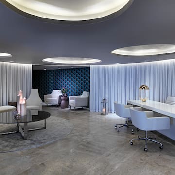 a room with white chairs and tables