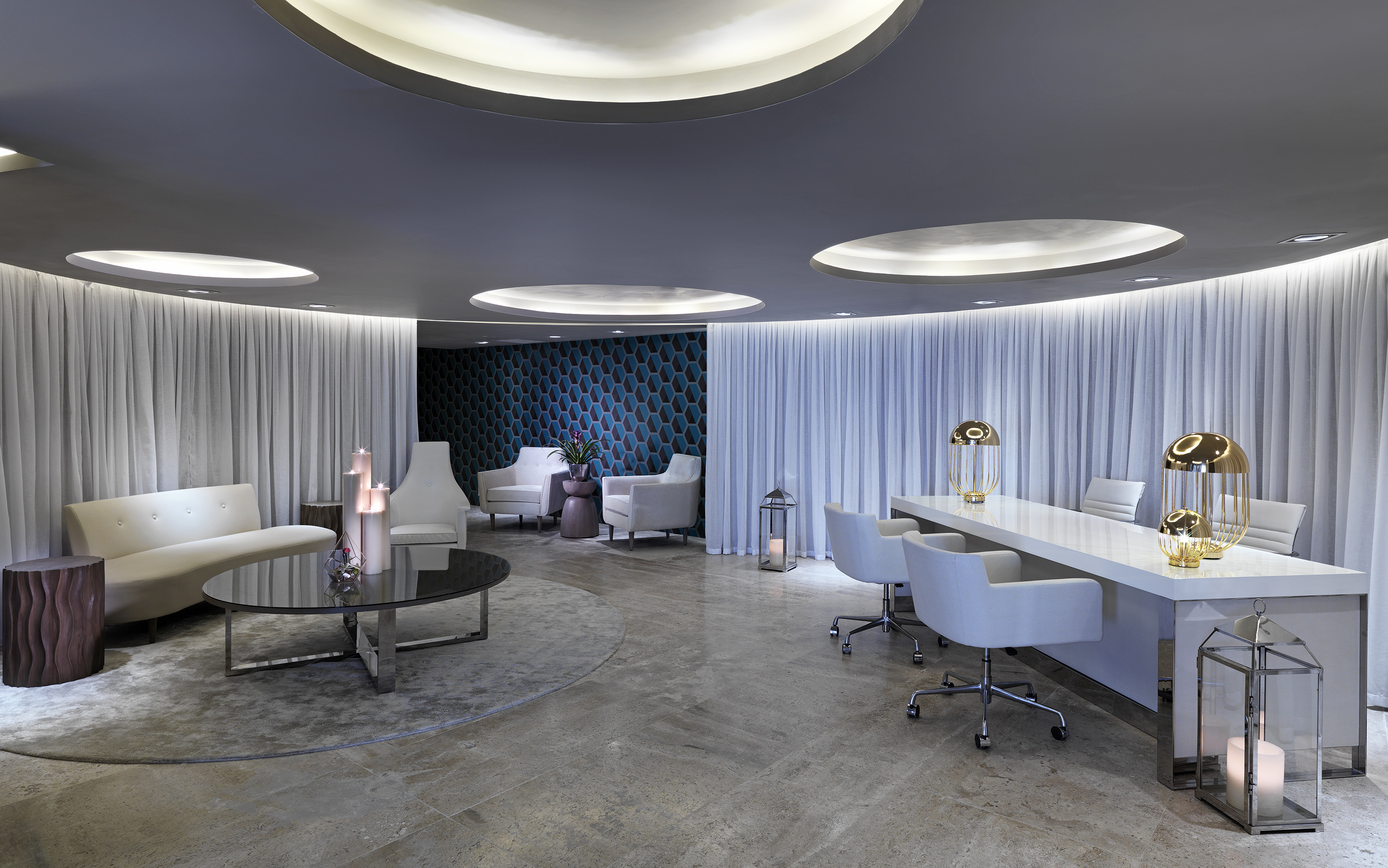 Modern luxury lobby interior with white furniture and ambient ceiling lights.