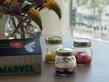 a group of jars with food on a table