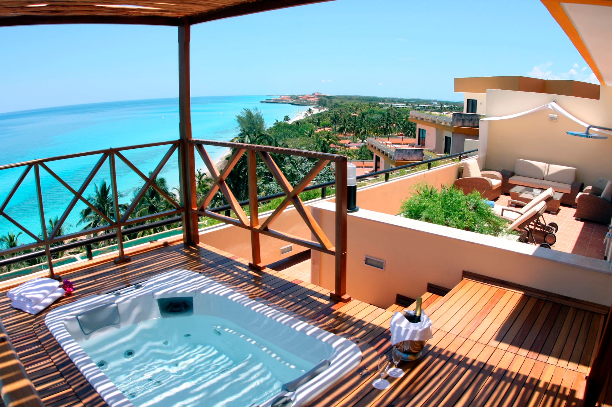 a hot tub on a deck overlooking a body of water