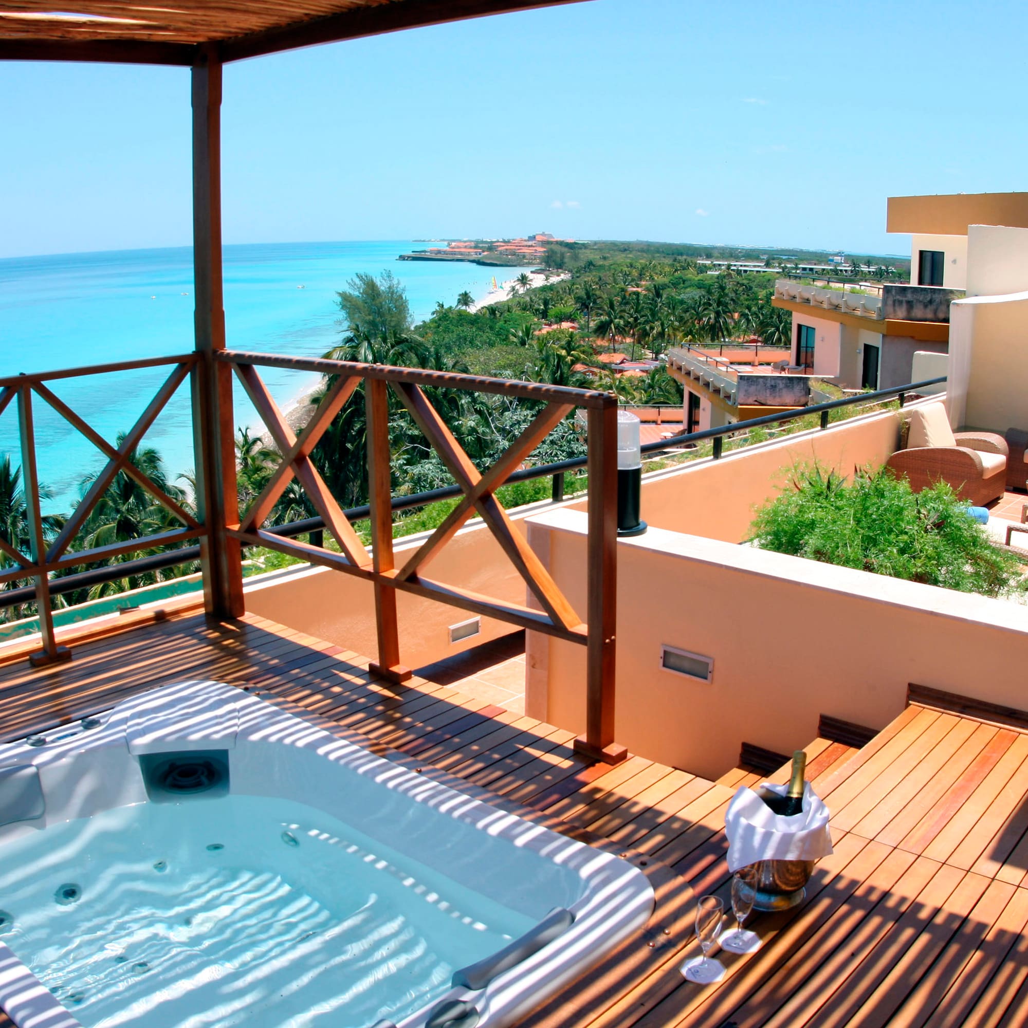 a hot tub on a deck overlooking a body of water