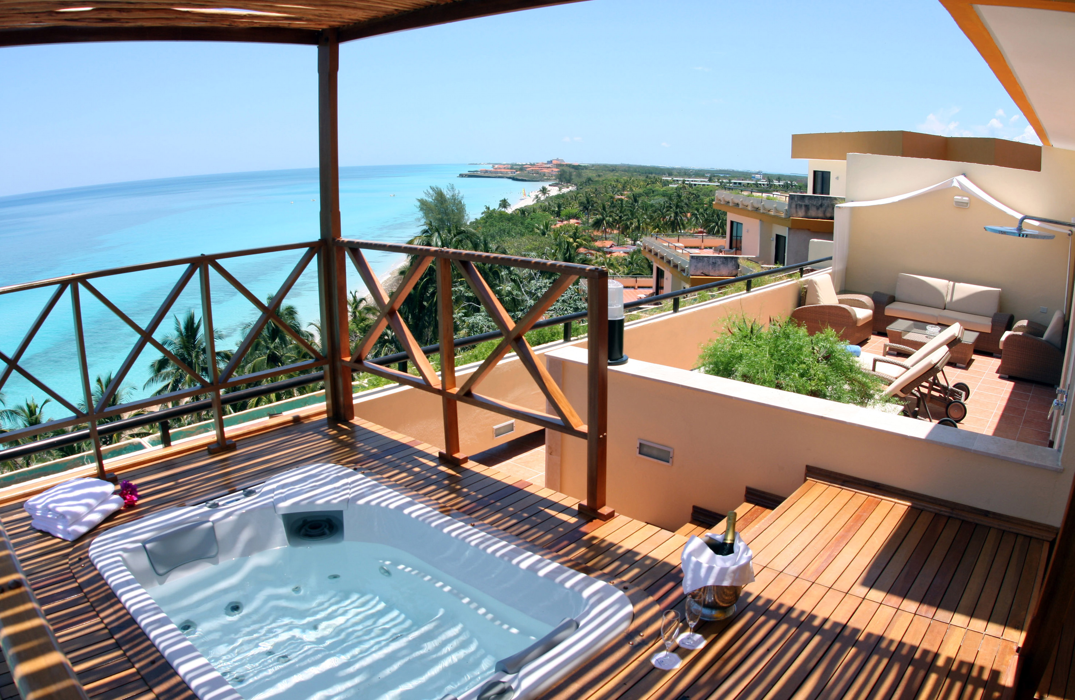 a hot tub on a deck overlooking a body of water