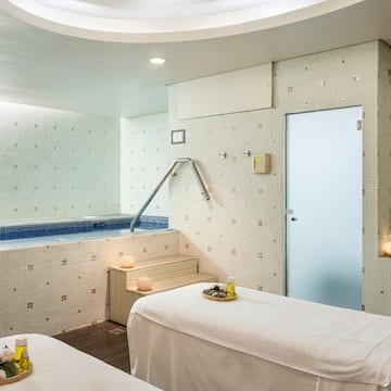 a massage room with a hot tub and massage table