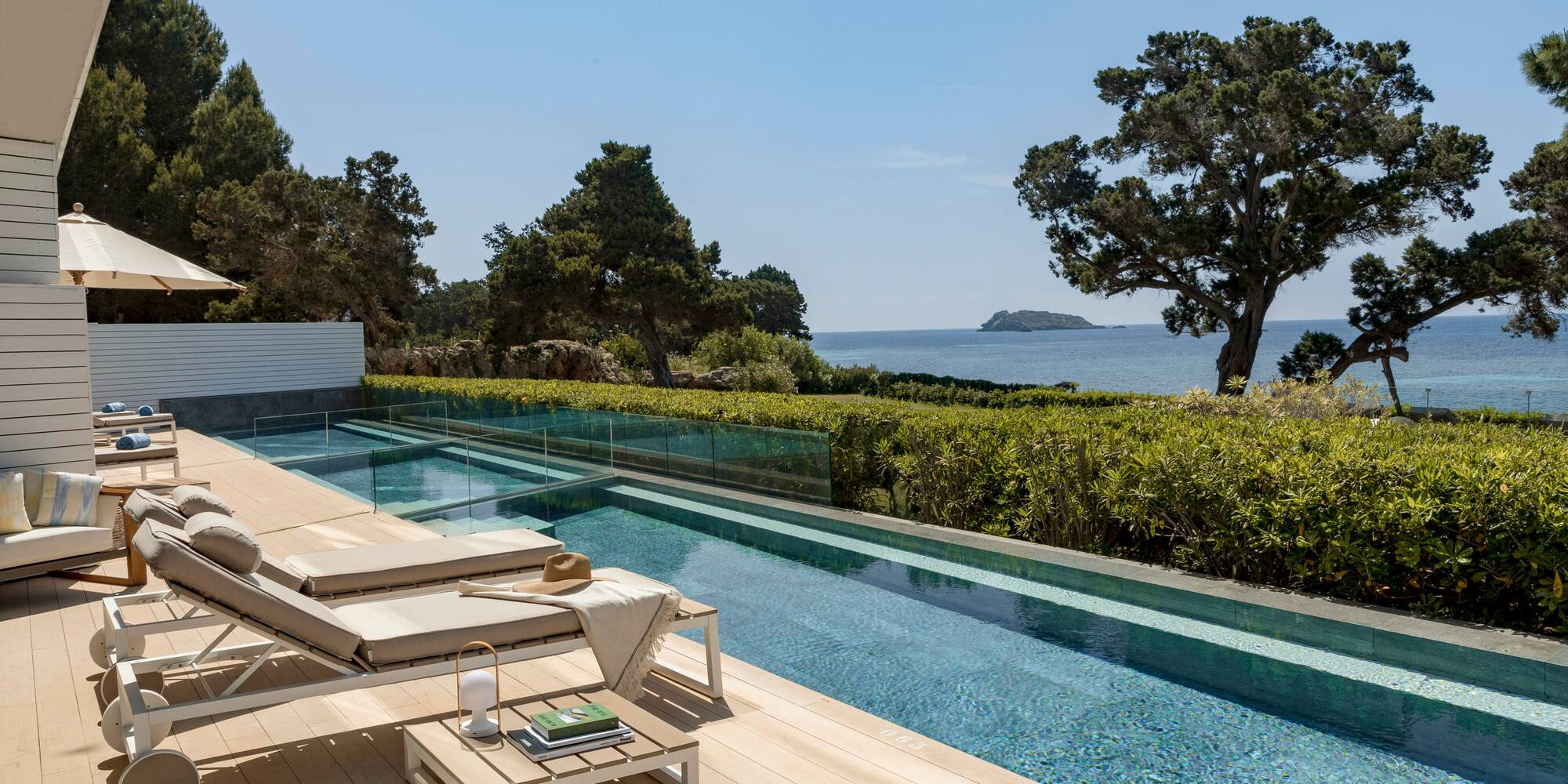 a pool with a deck and chairs