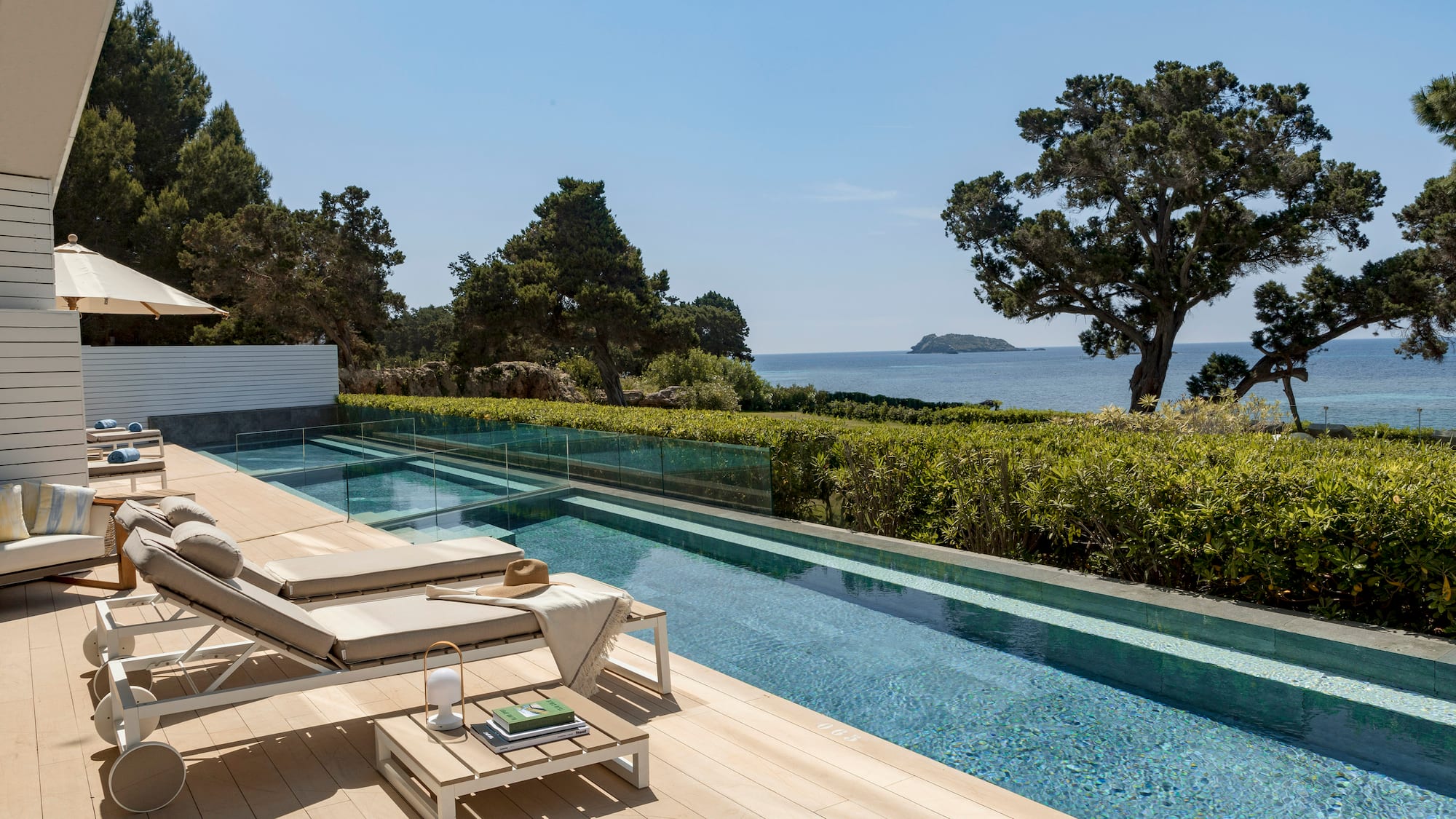a pool with a deck and chairs