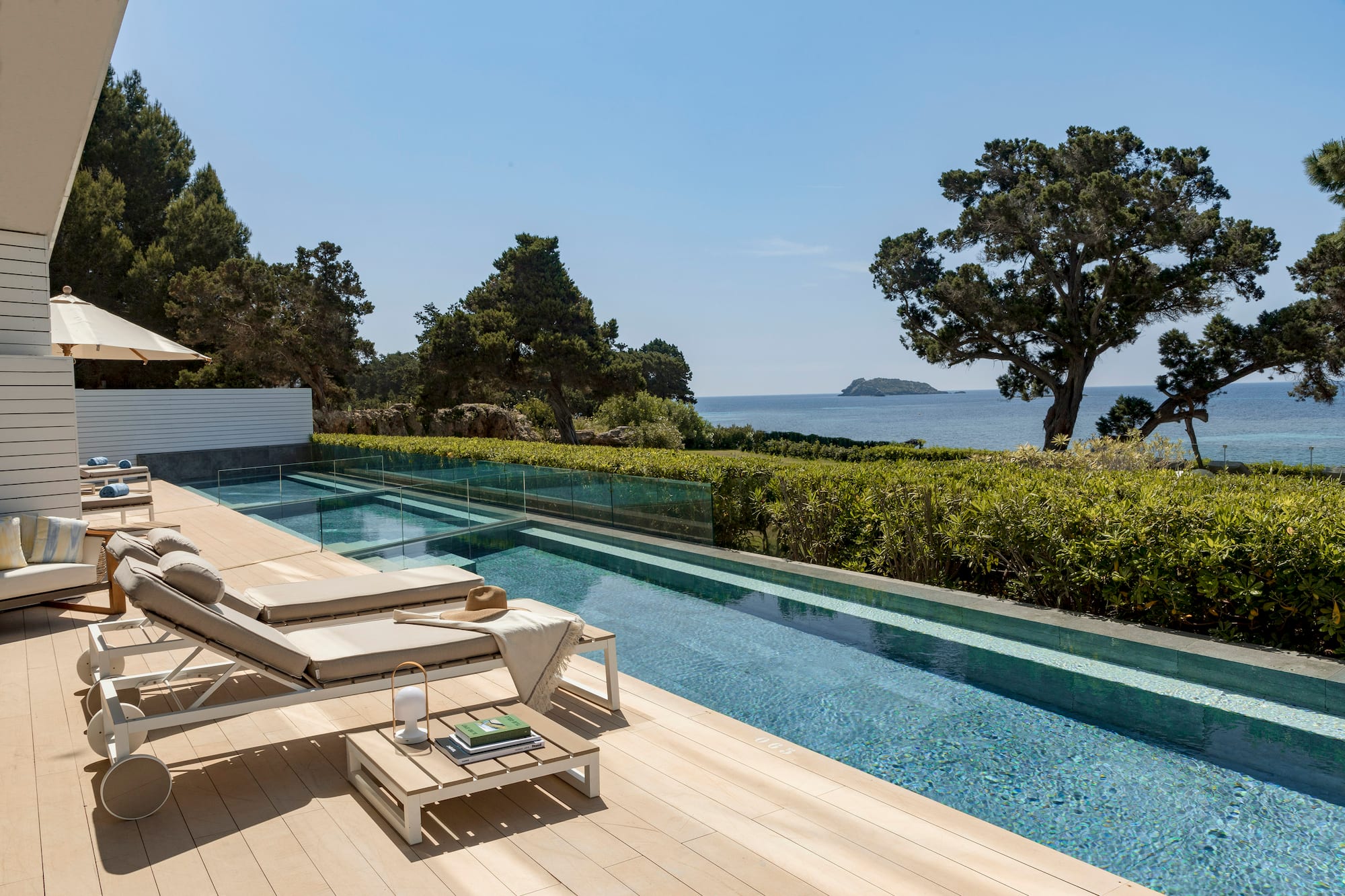 a pool with a deck and chairs