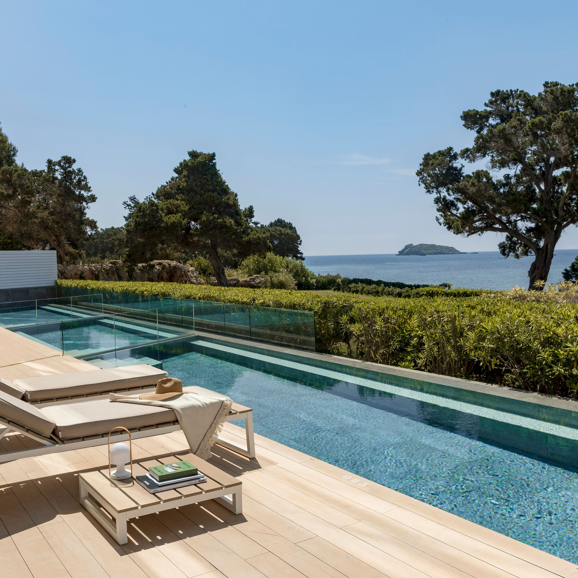 a pool with a deck and chairs