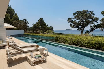 a pool with a deck and chairs