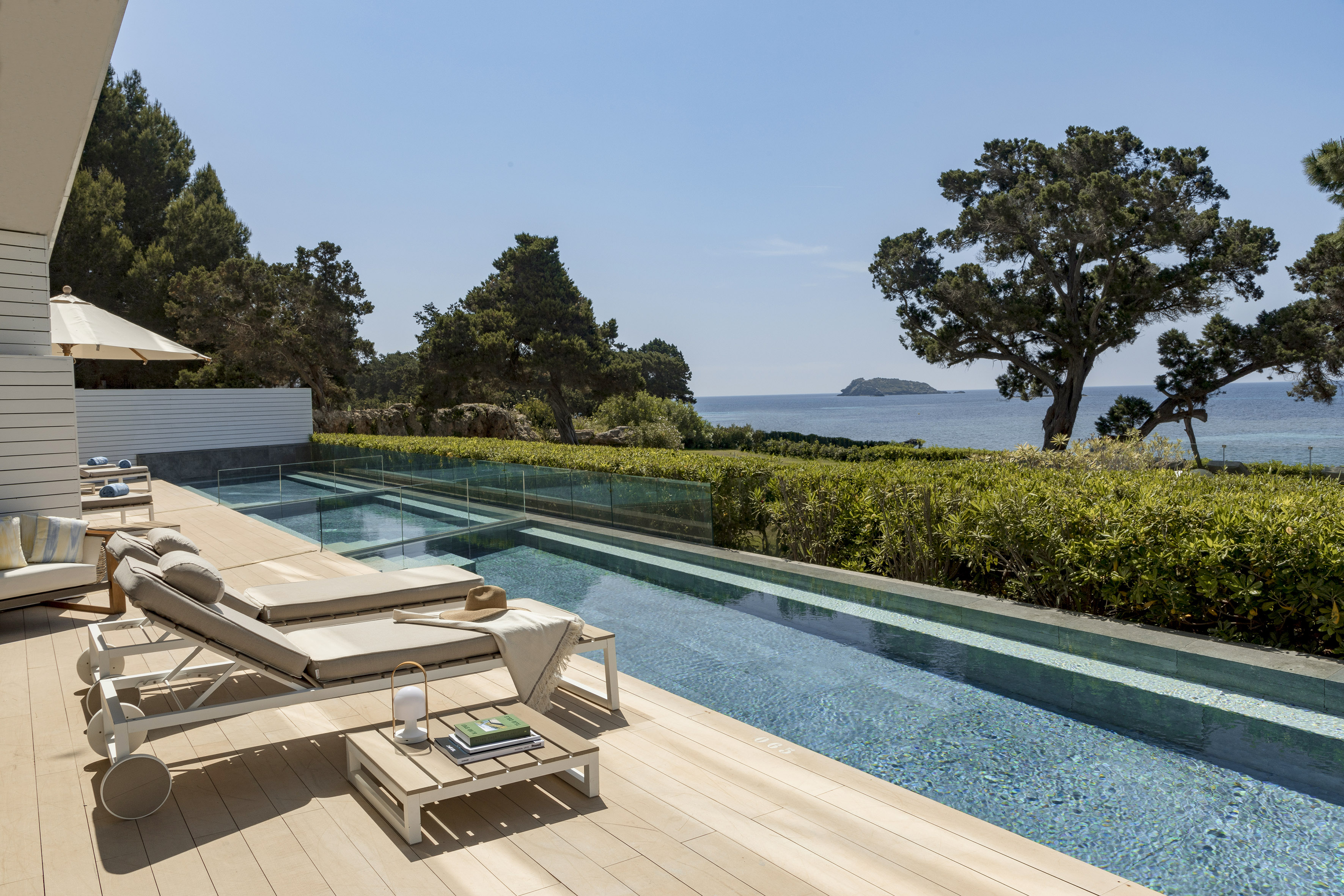 a pool with a deck and chairs