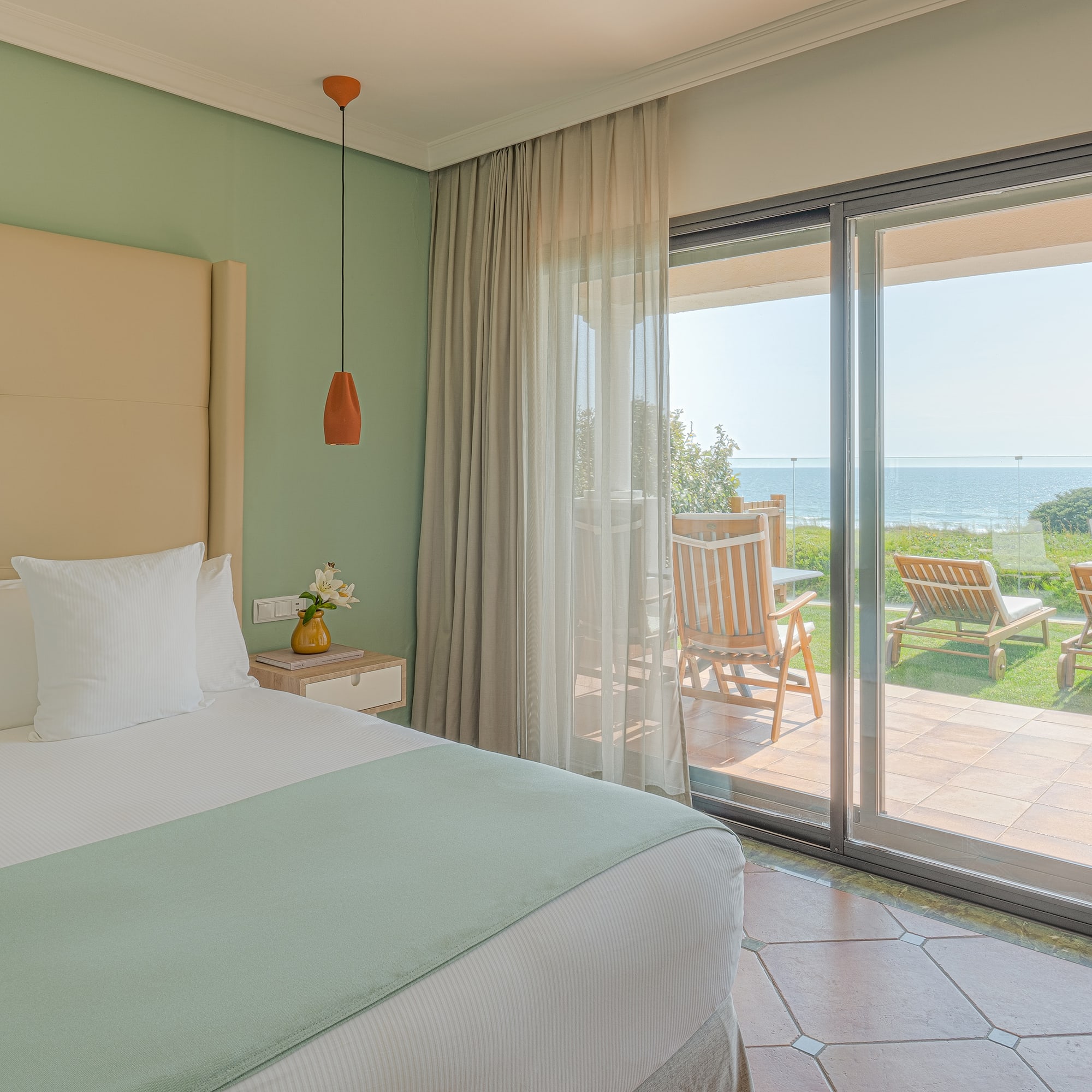 a bedroom with a large bed and a glass door