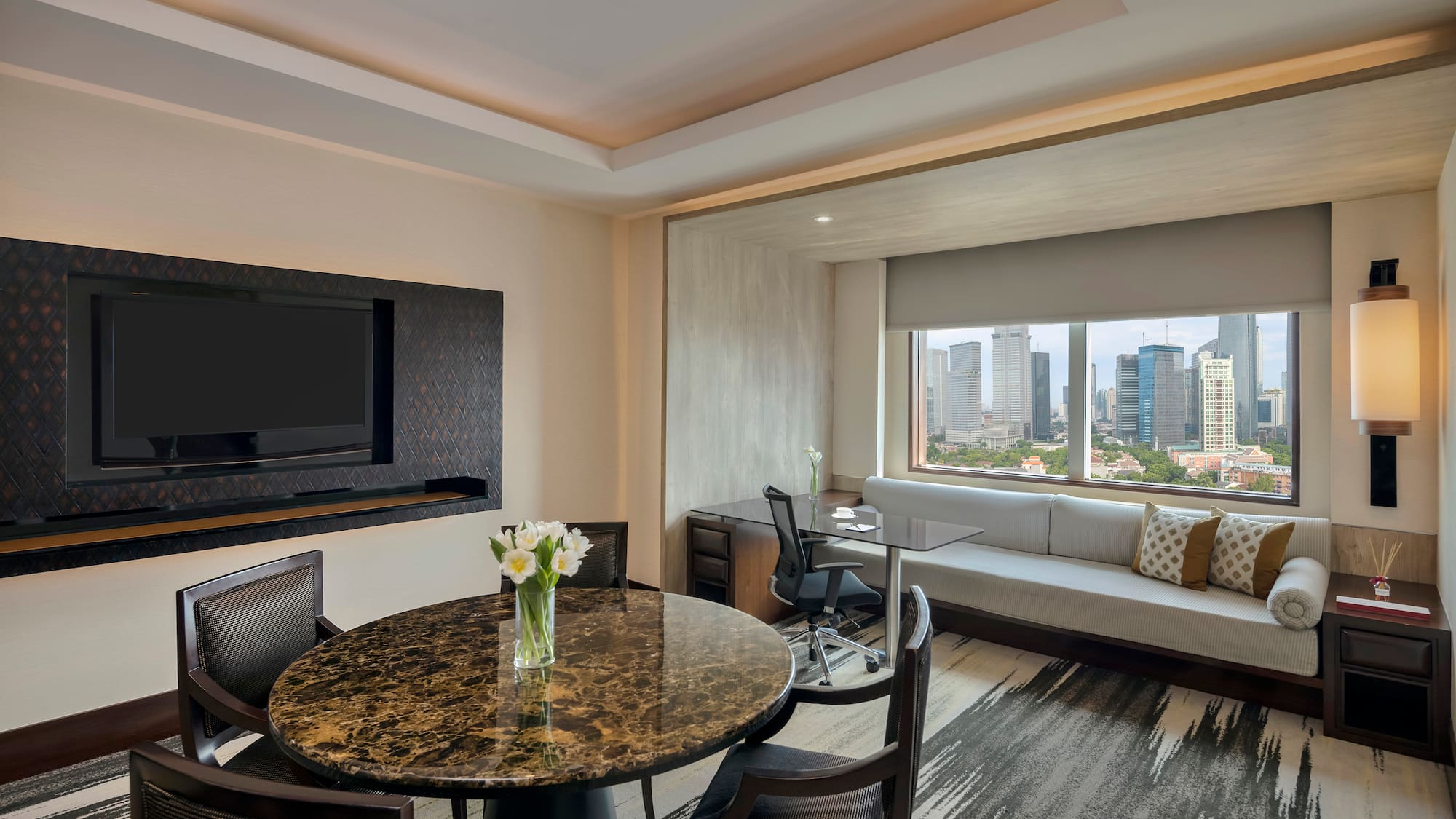 a room with a table and chairs and a television