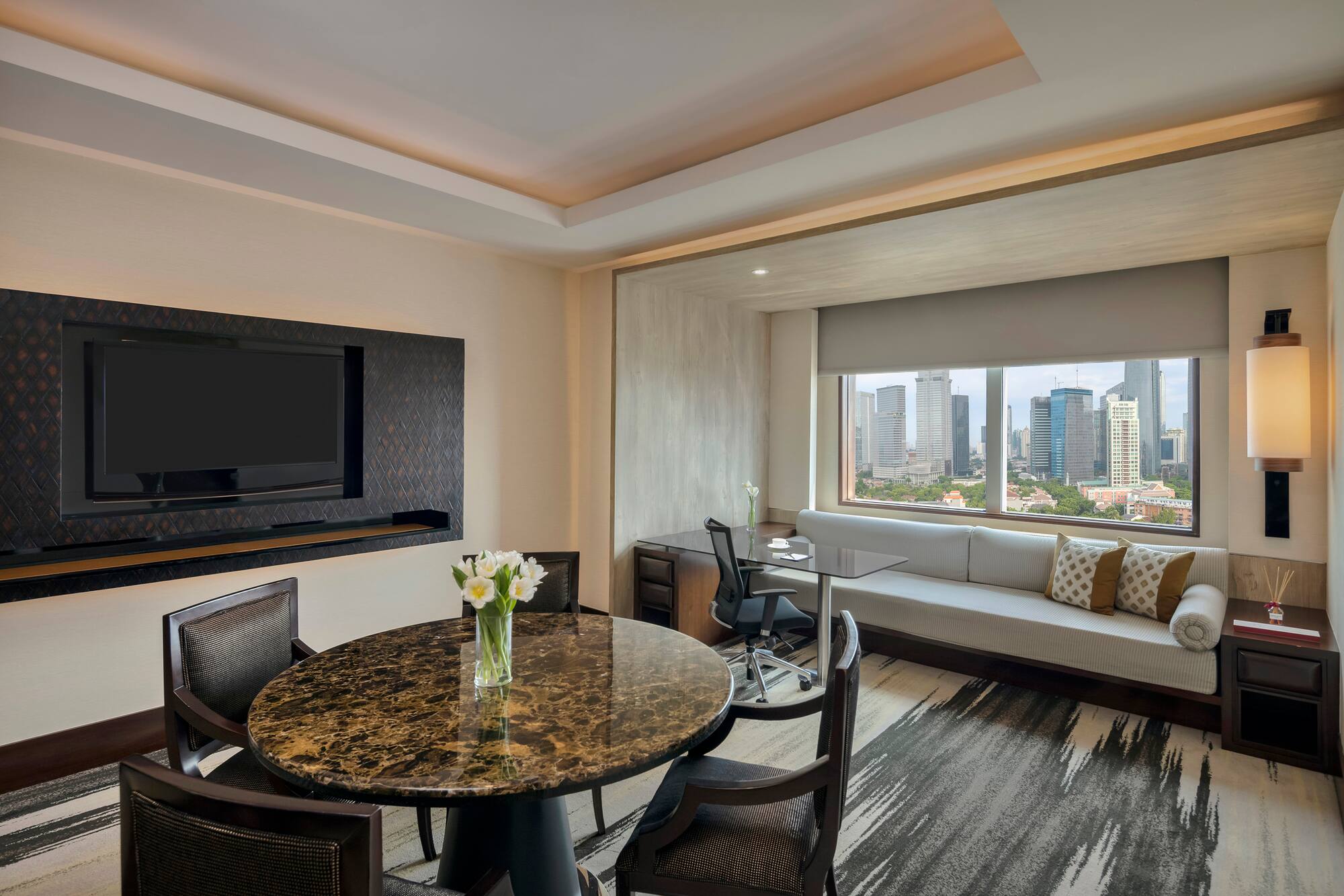 a room with a table and chairs and a television