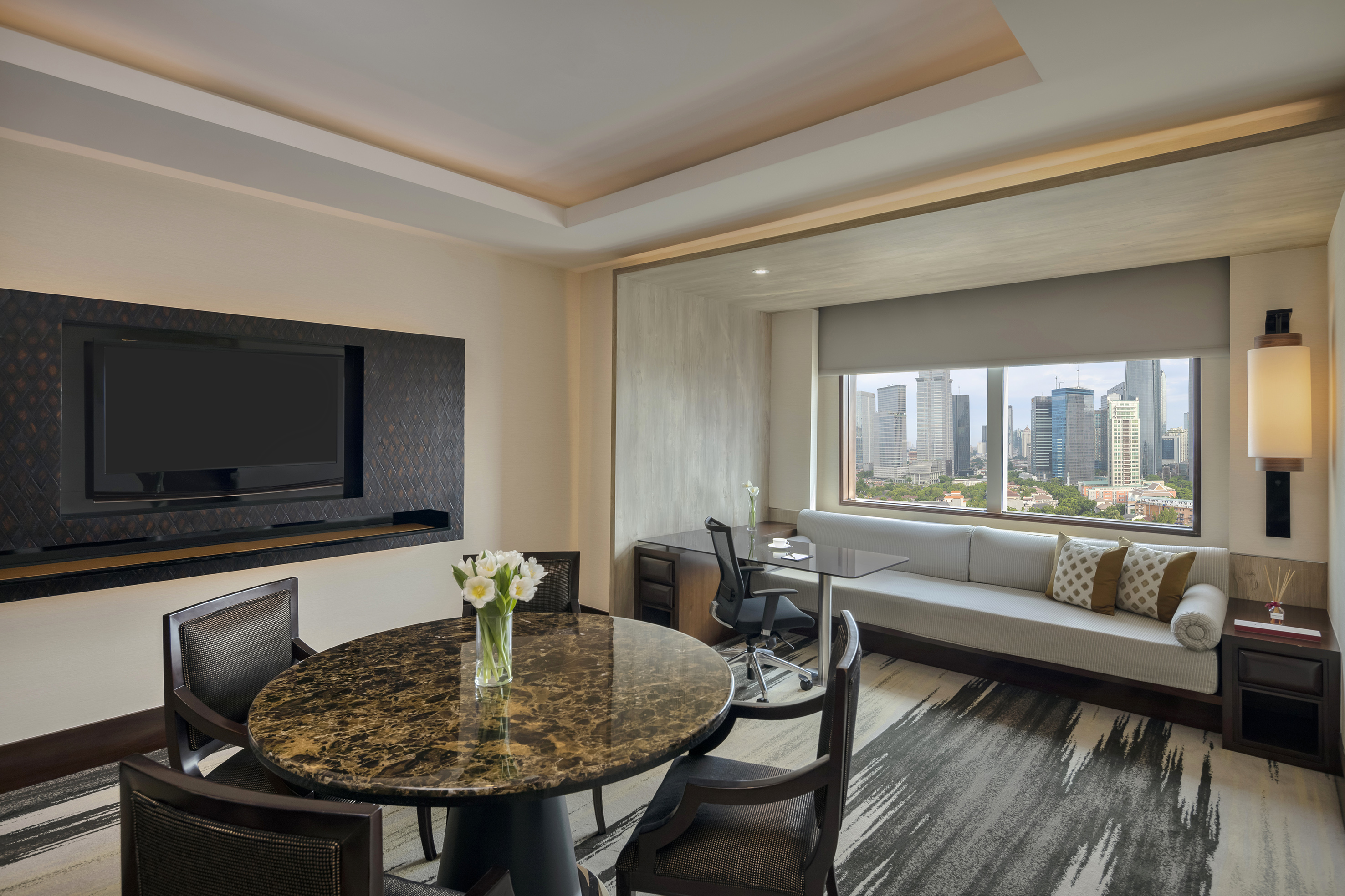 a room with a table and chairs and a television