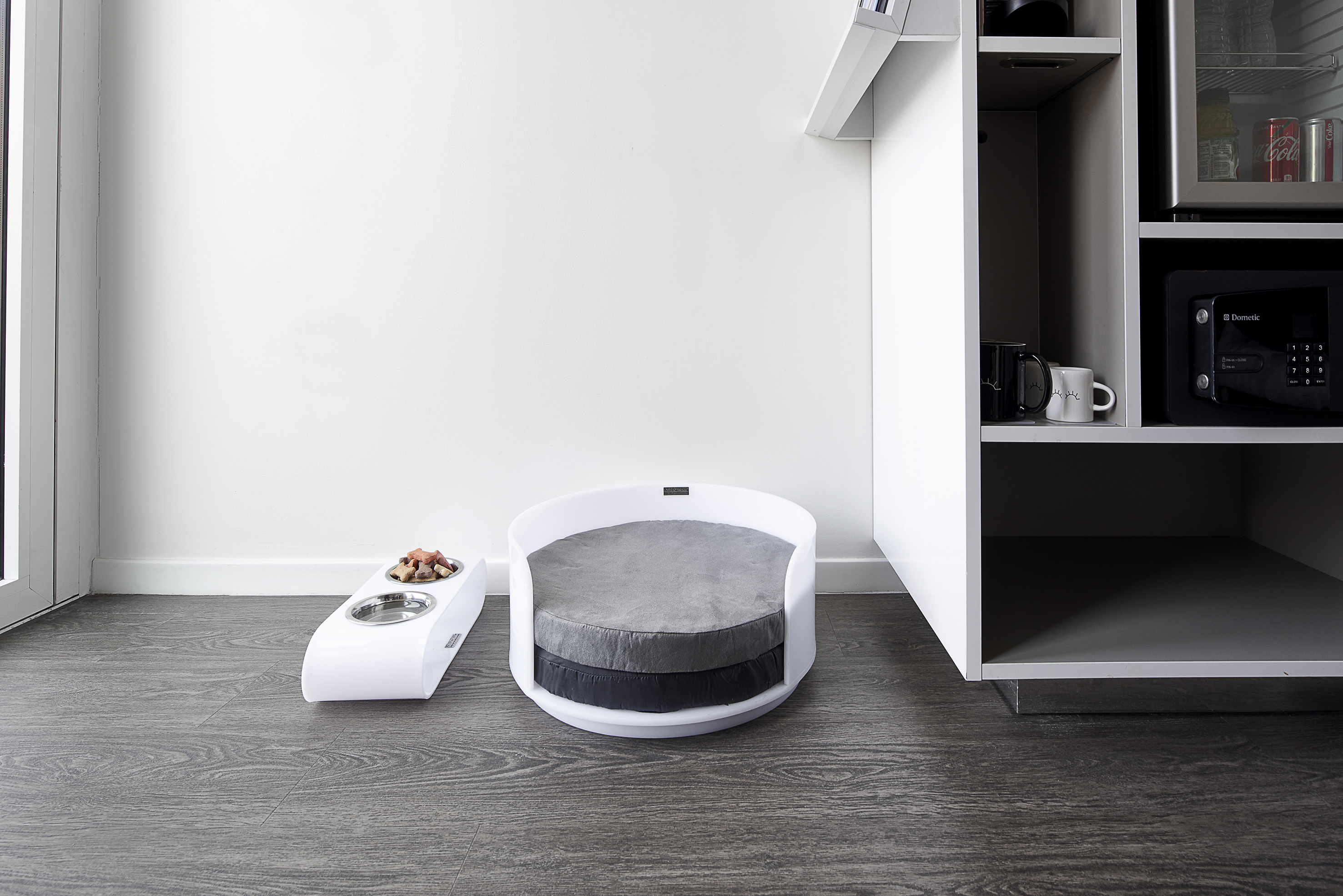 a dog bed and a bowl in a room