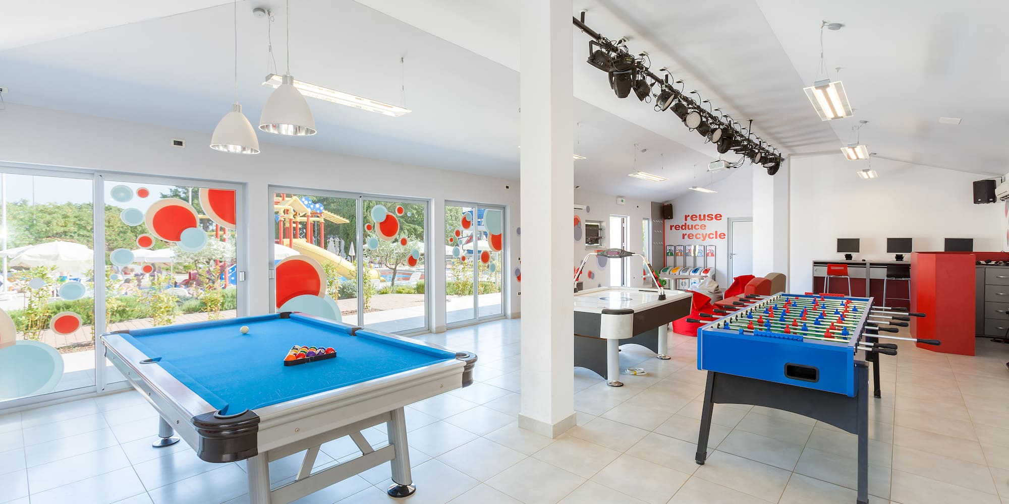 a room with pool tables and lights