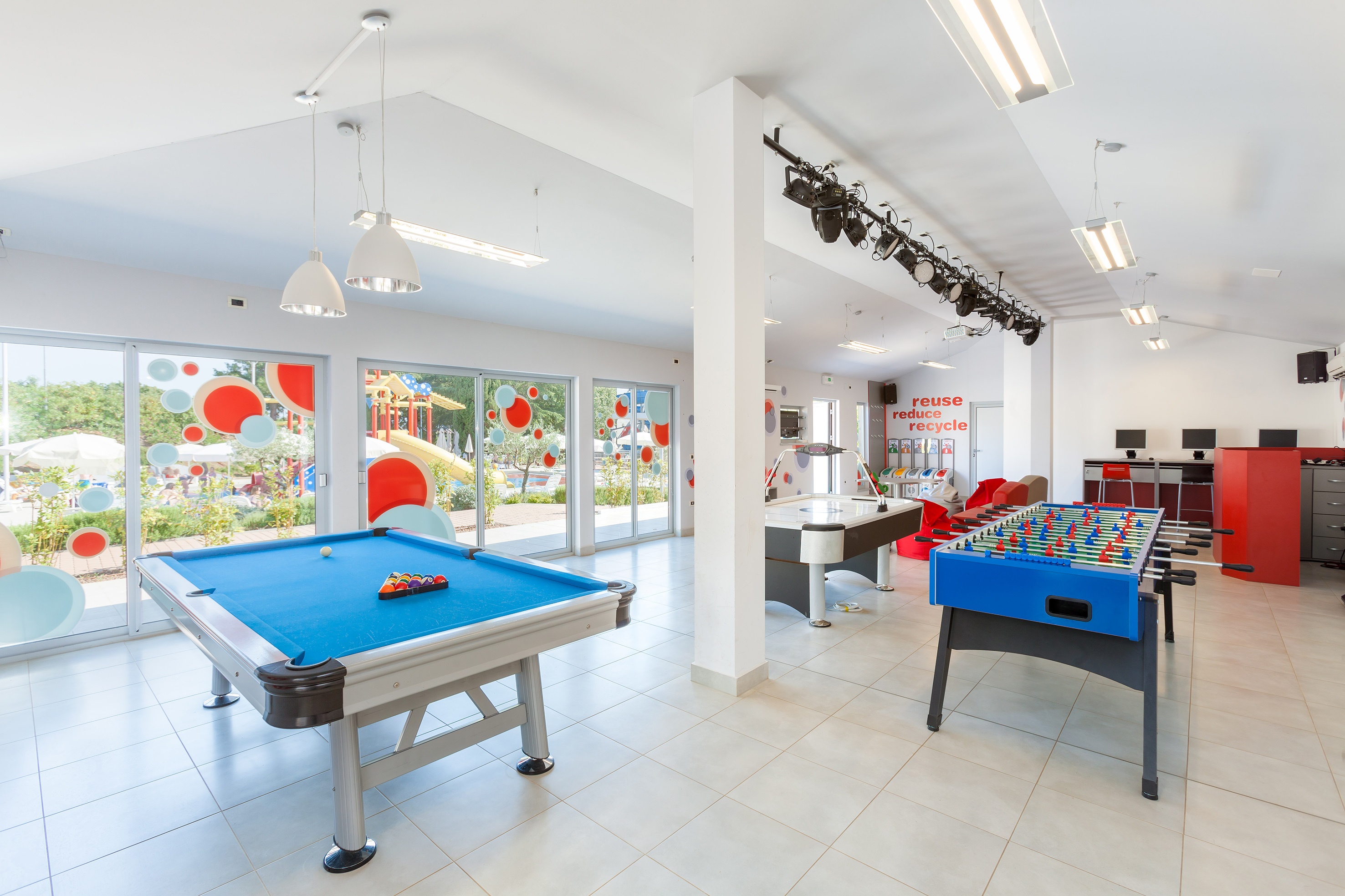 a room with pool tables and lights