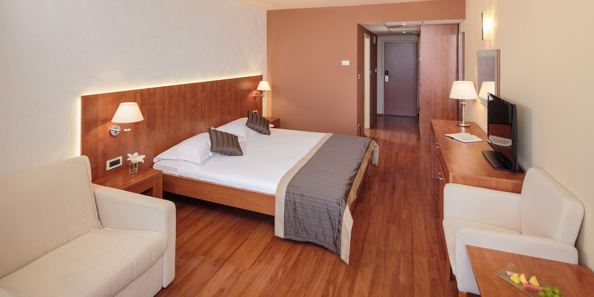 a room with a bed and a television