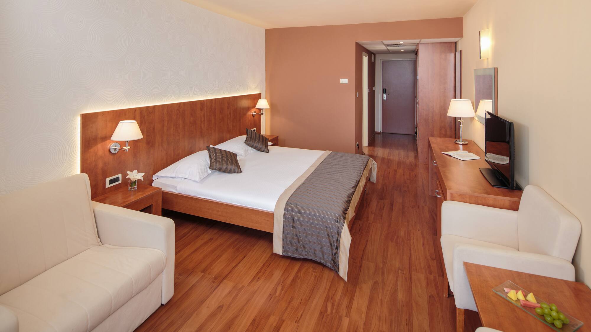 a room with a bed and a television