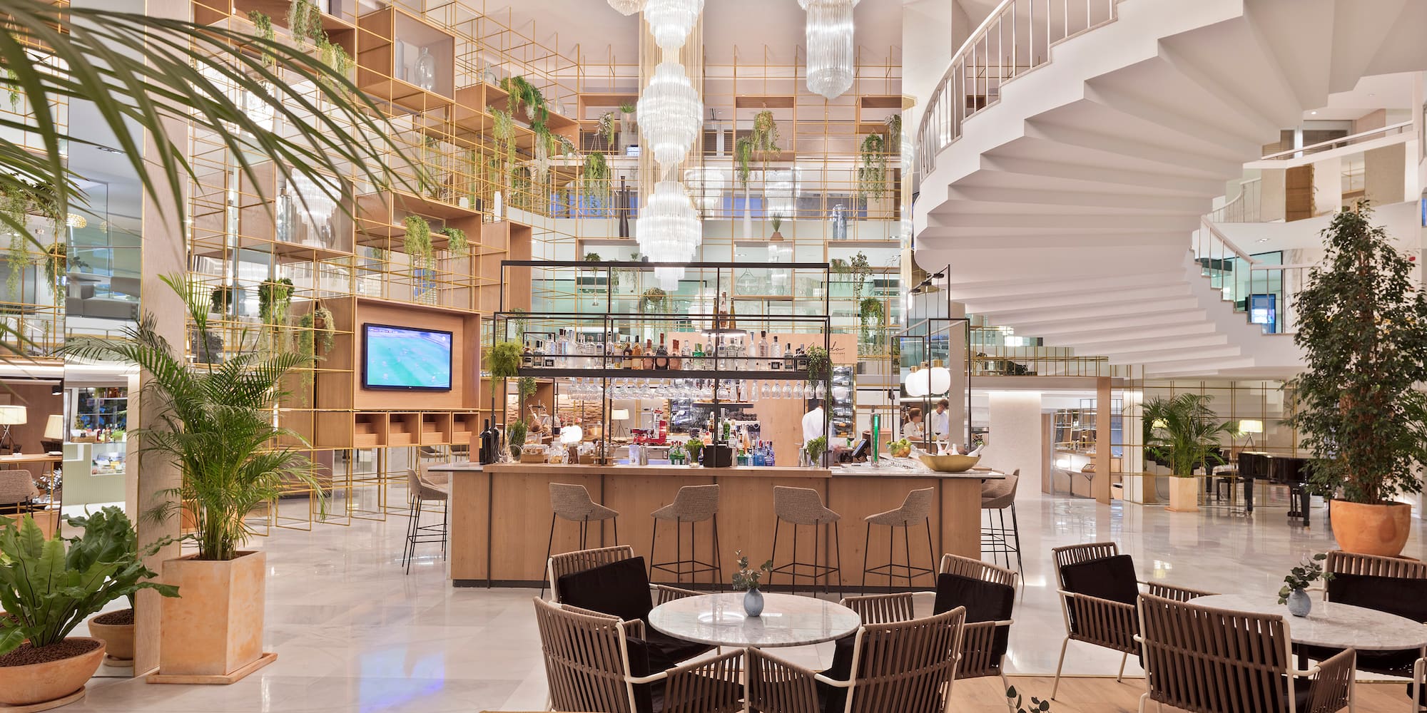 a room with a spiral staircase and tables and chairs