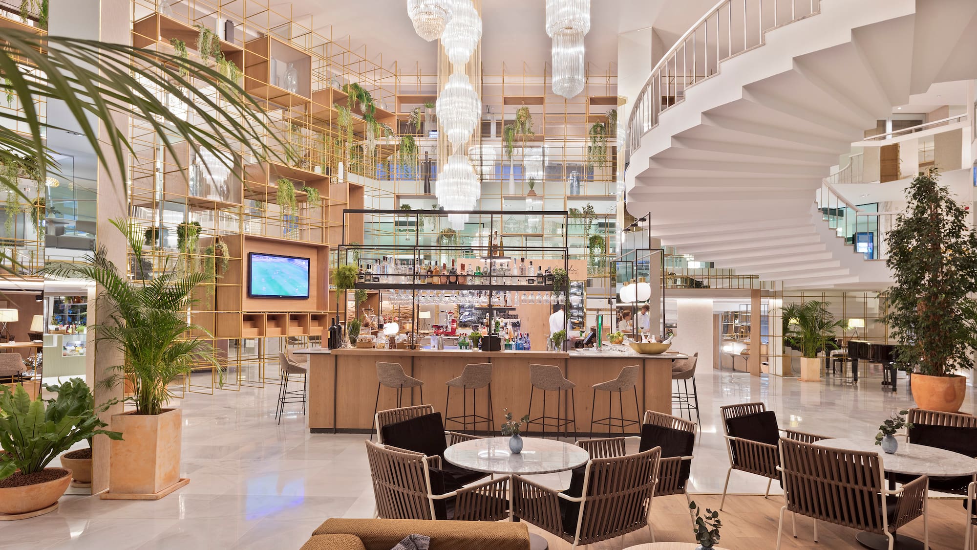 a room with a spiral staircase and tables and chairs