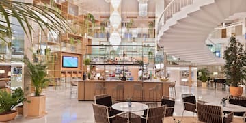 a room with a spiral staircase and tables and chairs