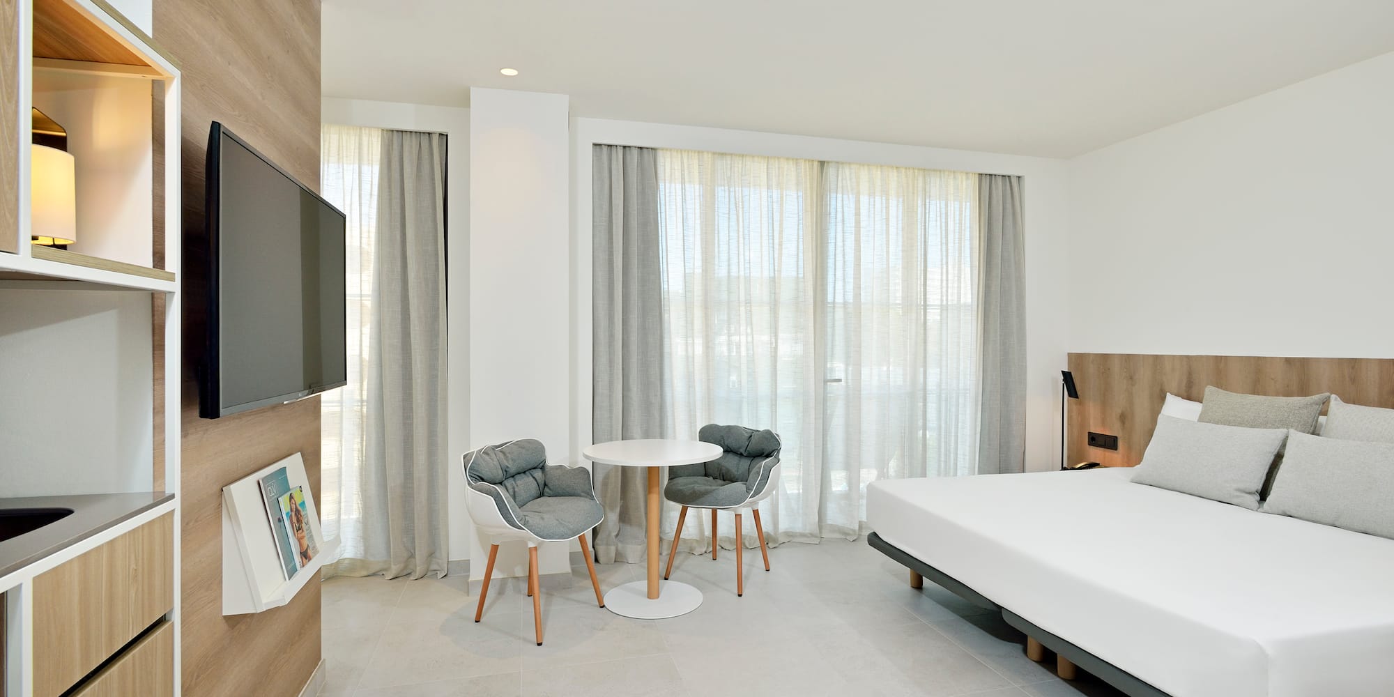 a room with a bed and a table and chairs