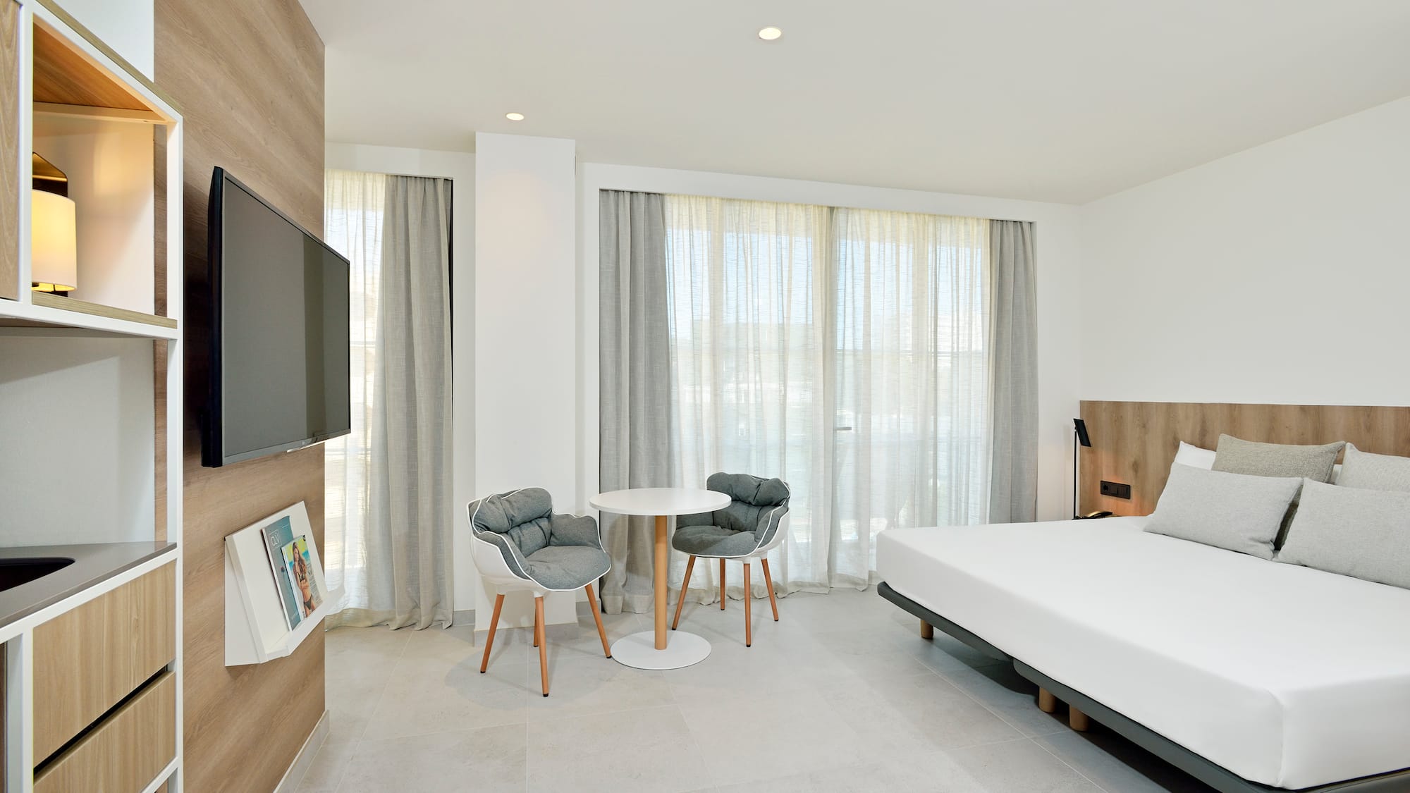 a room with a bed and a table and chairs