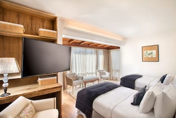 a room with two beds and a television