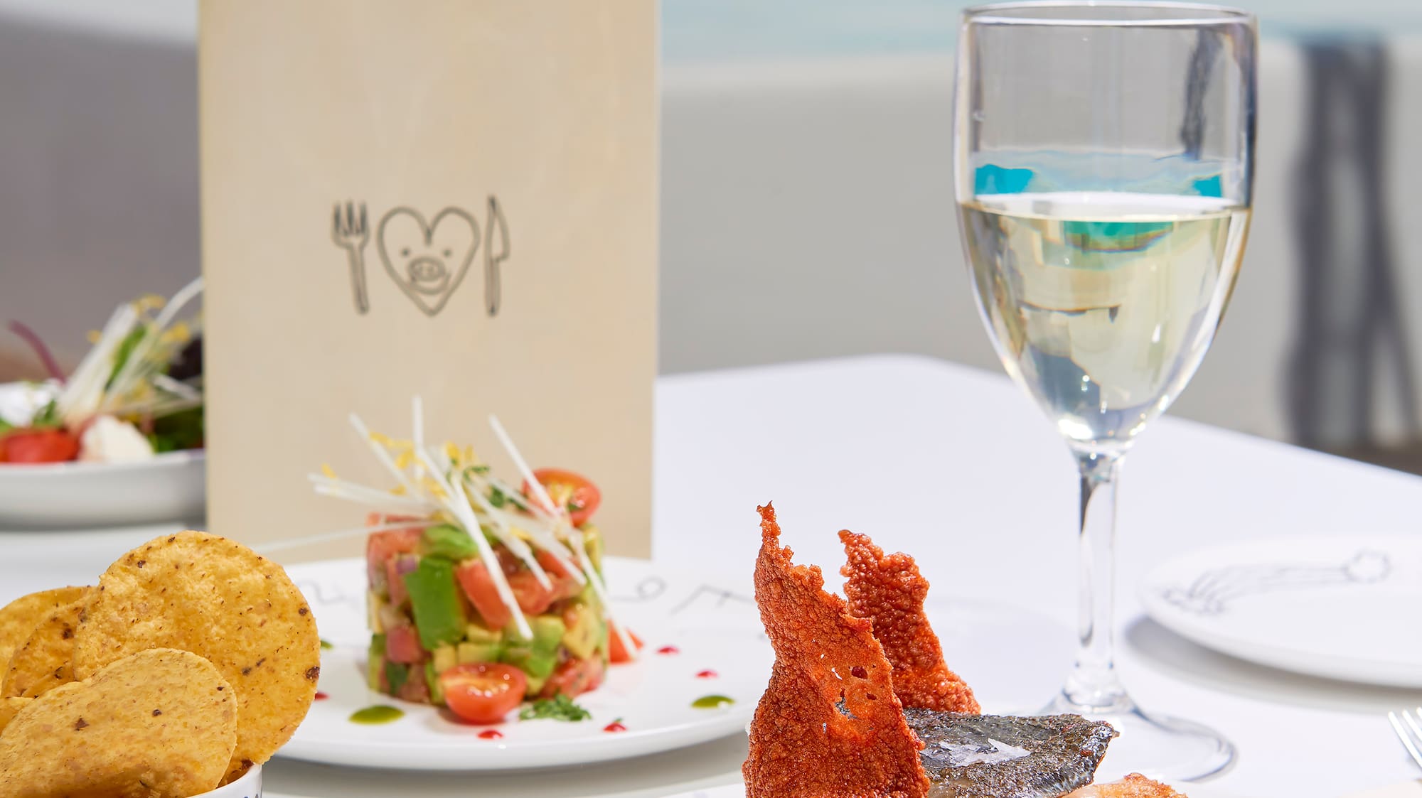 a plate of food and a glass of wine