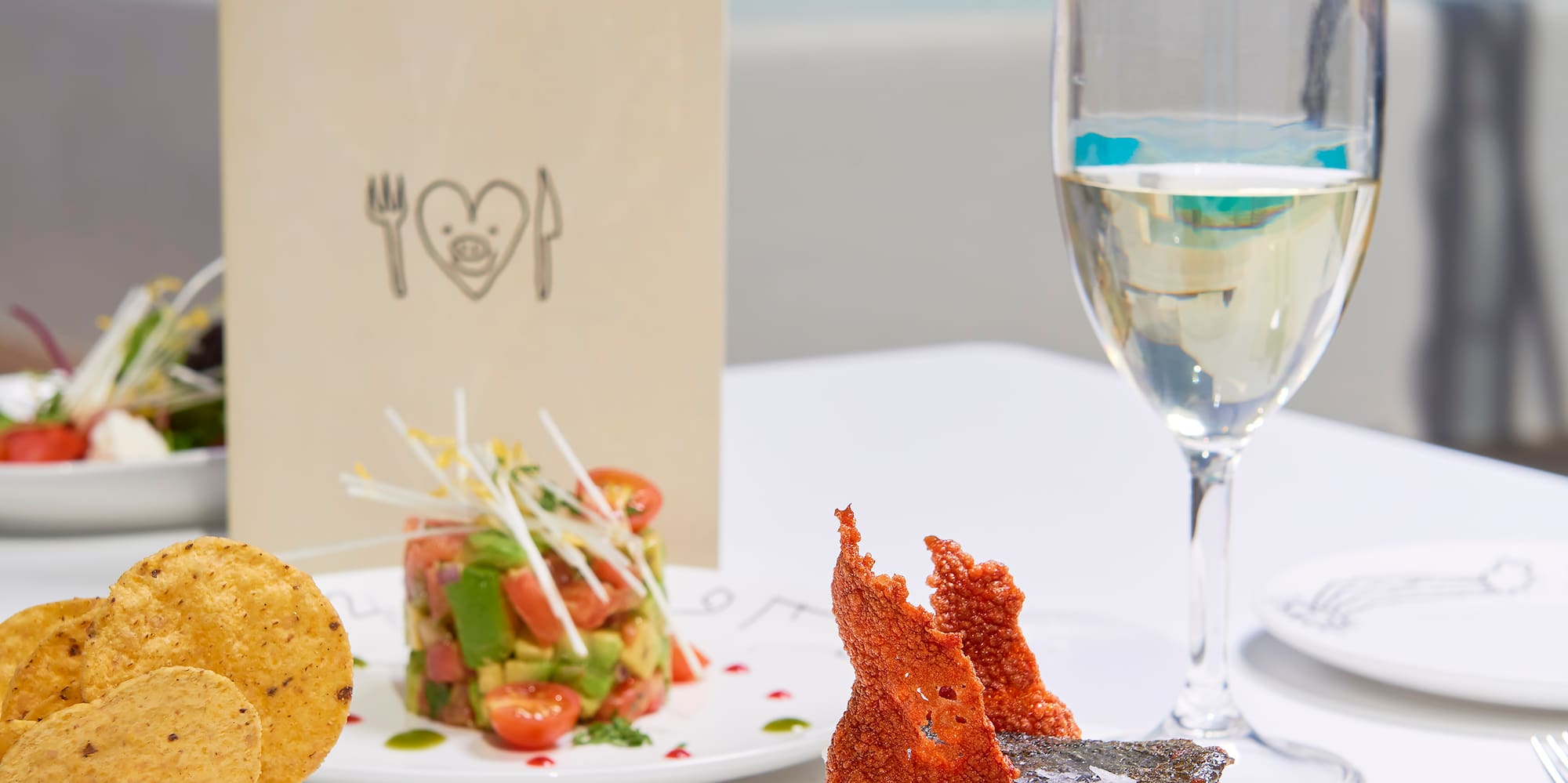 a plate of food and a glass of wine