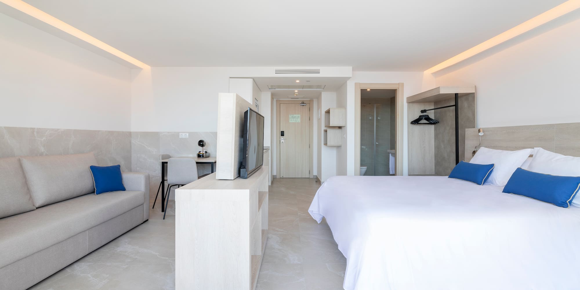 a bedroom with a bed and a television