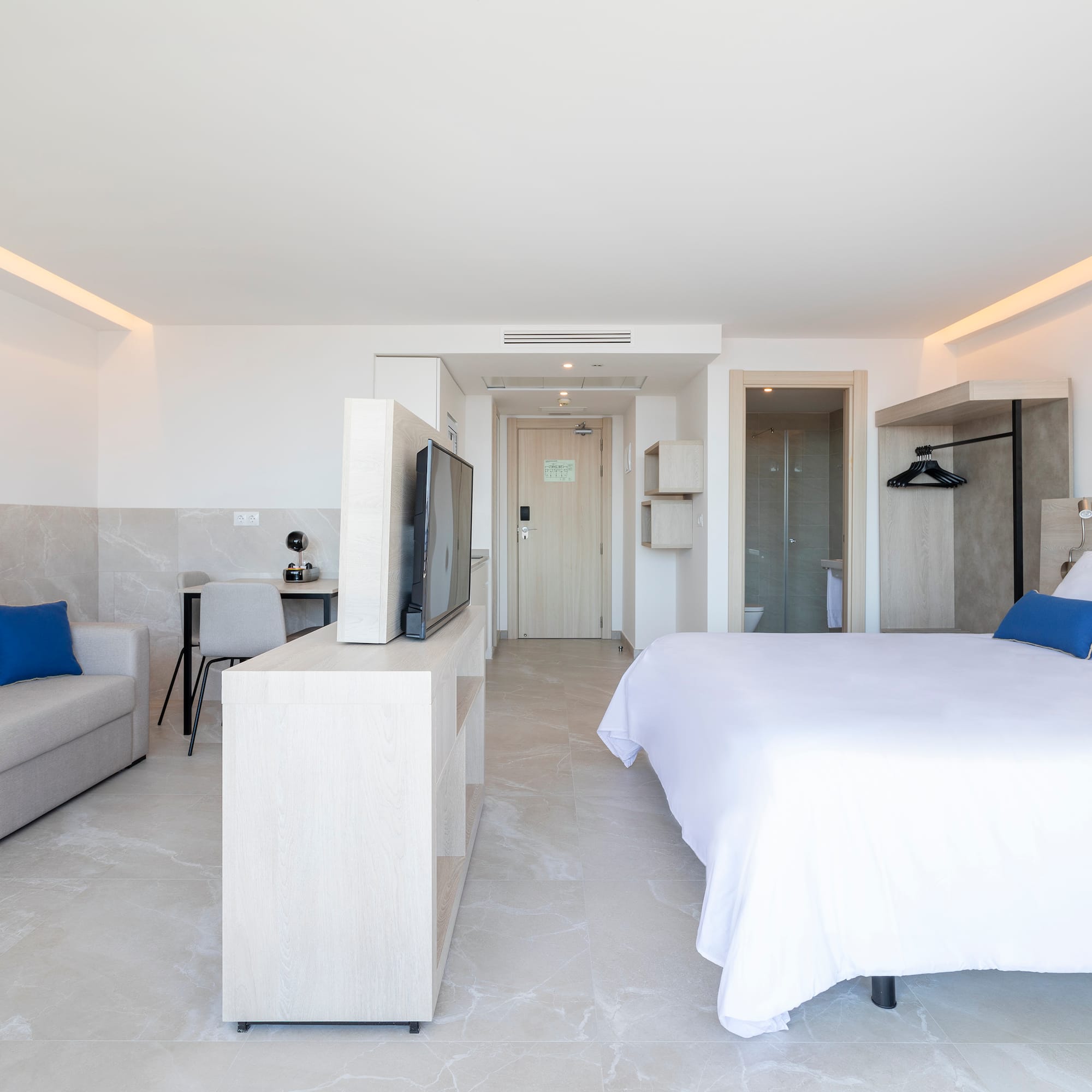 a bedroom with a bed and a television