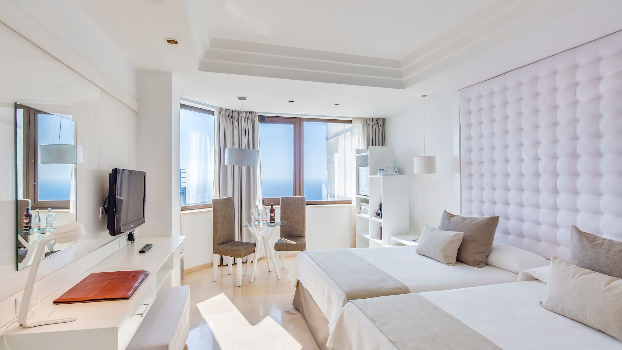 a room with two beds and a television