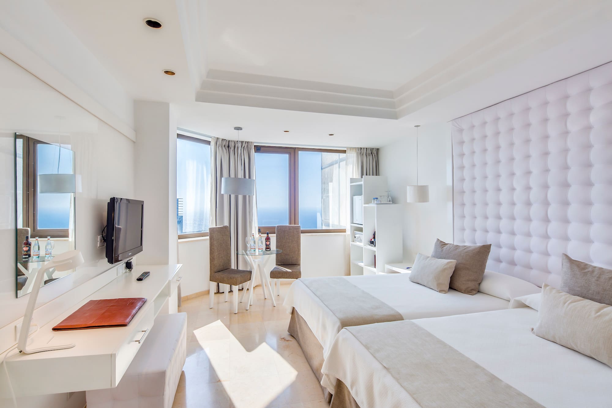 a room with two beds and a television