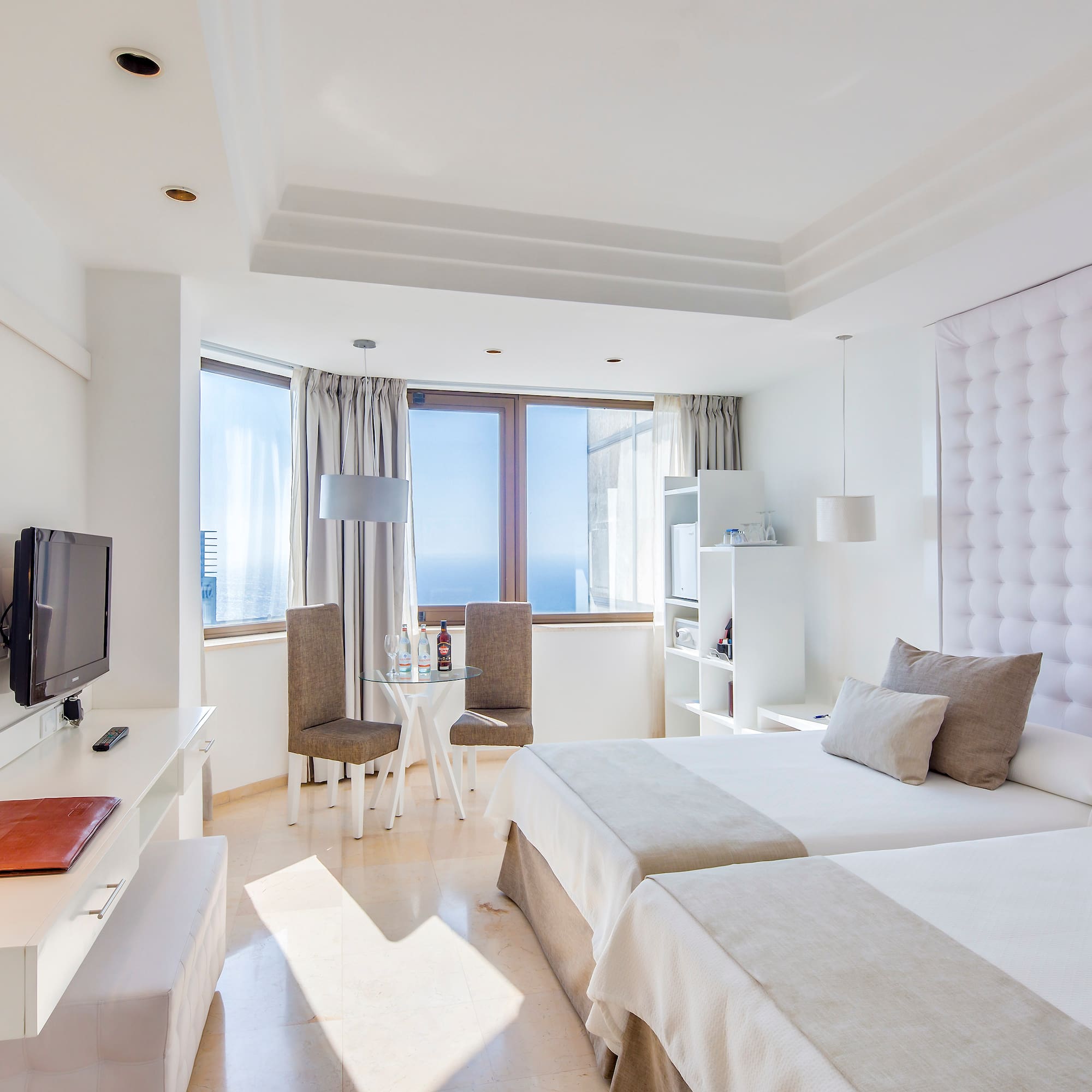 a room with two beds and a television