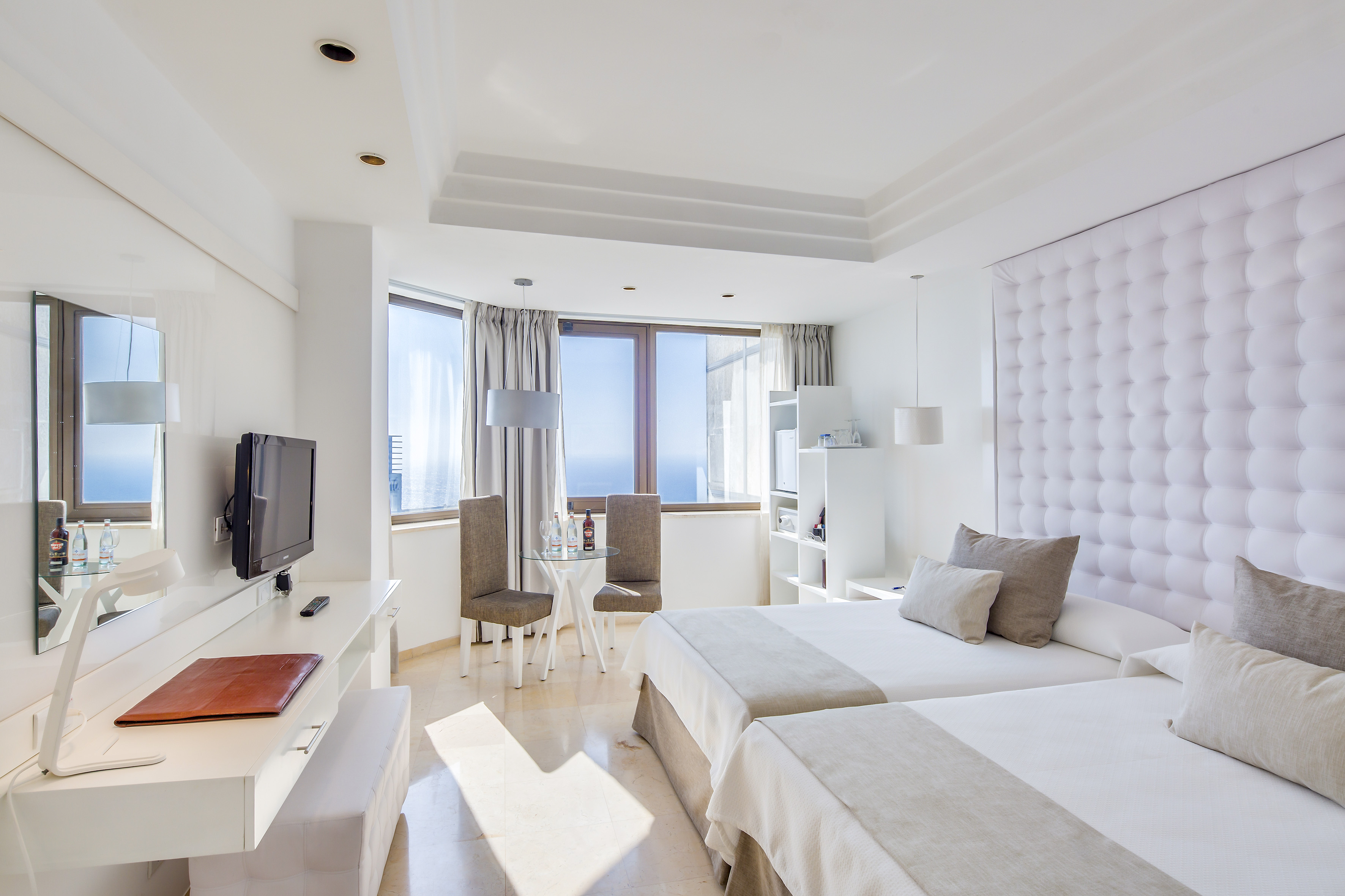 a room with two beds and a television