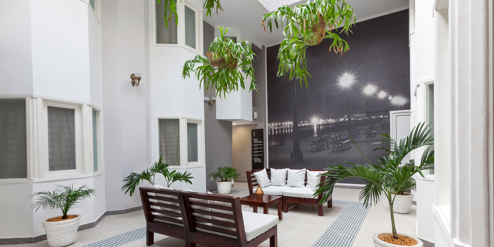 a room with white furniture and plants