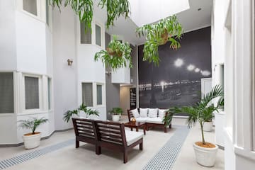 a room with white furniture and plants