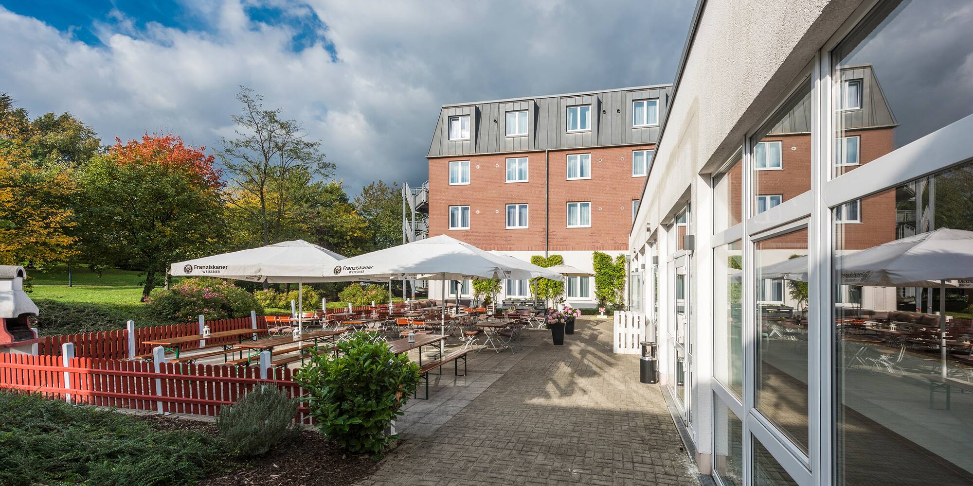 a building with a patio and umbrellas