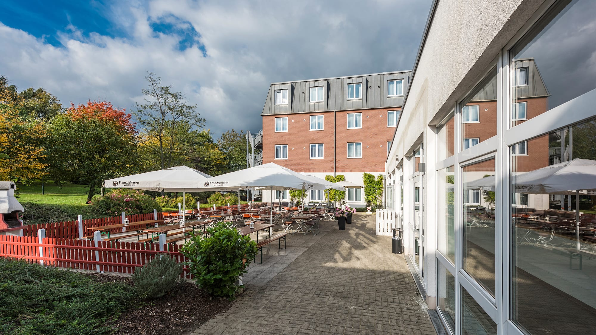 a building with a patio and umbrellas